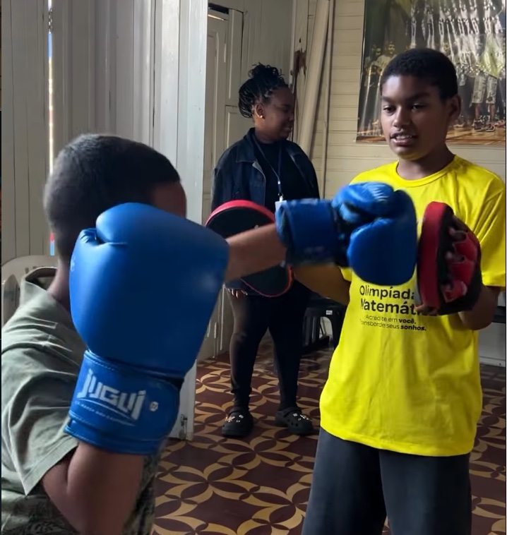 Criança participando de uma aula de kickboxe